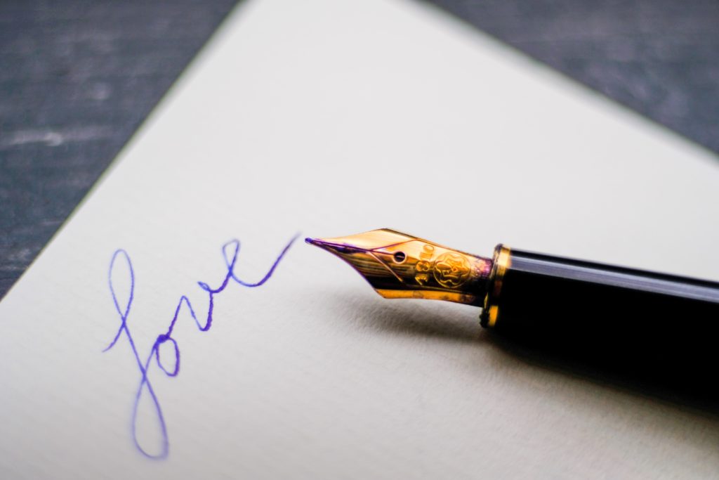 Letter writing love with an old ink pen. 📸 John Jennings - UnSplash