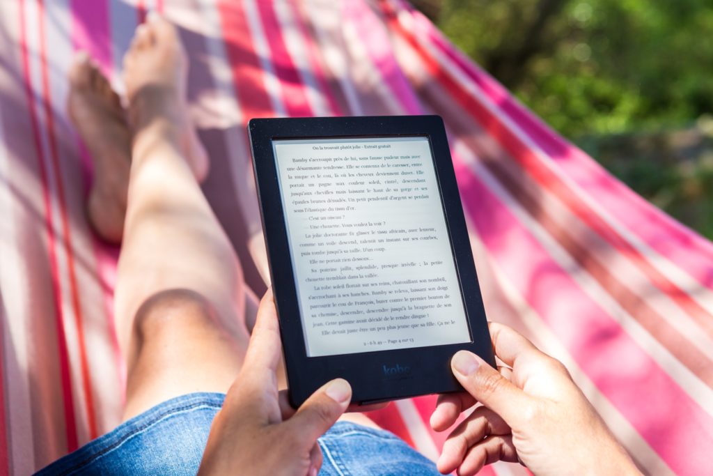 Summer reading from an e-reader in a hammock.